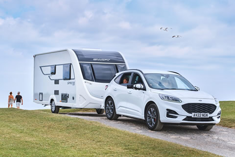 A car towing a Swift touring caravan