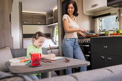 Child sat at table in a Swift caravan