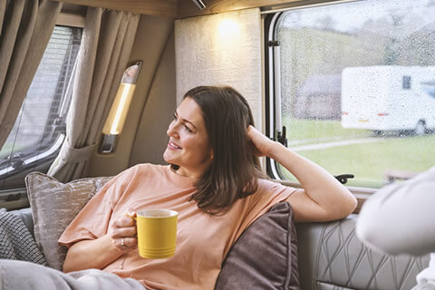 Woman relaxing in a caravan